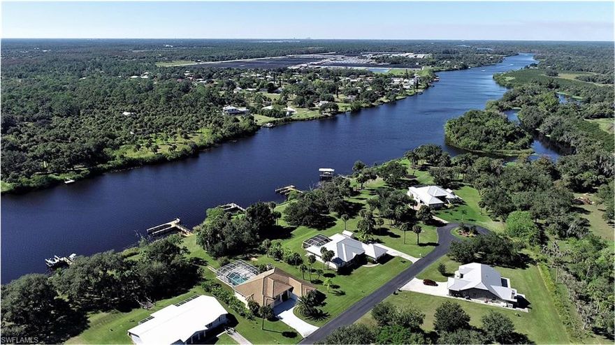 Enjoy the view of yachts passing by your Riverfront home in Alva. Yes this is on the intracoastal waterway crossing south Florida.  A solid concrete home built with Polysteel (R-30) walls. Not your normal, ordinary construction. Features a metal roof, a whole home R/O system, 20k Kohler generator, 80 gal lifetime water-heater and a new Trane A/C system (2020). Come and relax, this home is low maintenance with upgrades just completed in the last few years. The kitchen was just completed by Cornerstone with quartz countertops and a grand large island. Newer upgraded bathrooms featuring an extra large master shower. Tile flooring throughout the home is another maintenance free extra. Morning coffee outback in your 40' long porch is a great place to view the river. All in a small community of one + /- acre homes well named "Riverside At Alva". 
Price includes personal property, all furniture and lawn mower (except Master bedroom furniture). Come see what all the fuss is about living in Alva. River bank is owned by South Fla Water Mgmt Dist