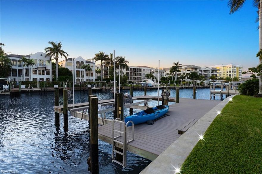 Framed by long, southwest-facing water views, this exceptional waterfront residence in Coquina Sands enjoys a tranquil setting along the quiet enclave of Hurricane Harbor Lane in Naples. Offering approximately 150 feet of water frontage and the rare luxury of sunsets year-round, the property spans just under half an acre and provides an extraordinary sense of openness and privacy, with sweeping water vistas serving as a stunning daily backdrop.
Thoughtfully oriented to embrace its remarkable setting, the home features a light, bright interior where the main living spaces flow effortlessly toward the water, creating a seamless indoor-outdoor lifestyle. Expansive windows invite natural light throughout, while tranquil water views remain the focal point from many vantage points within the home. Outdoors, a spacious pool and lounging area provides the perfect setting for both relaxed afternoons and elegant entertaining. A newly constructed seawall and private dock, completed in 2020, are complemented by a boat lift with an impressive 25,000-pound capacity—ideal for accommodating a sizable vessel and providing effortless access to the surrounding waterways for boating and paddleboarding adventures.  Additional highlights include a durable metal roof, a freshly refreshed interior, and a highly desirable lot shape and size that presents exceptional future redevelopment potential. Ideally located just moments from the sugar-sand beaches of the Gulf and the renowned dining, shopping, and cultural offerings of downtown Naples, this property represents a rare opportunity to enjoy peaceful waterfront living in one of Naples’ most coveted coastal neighborhoods.