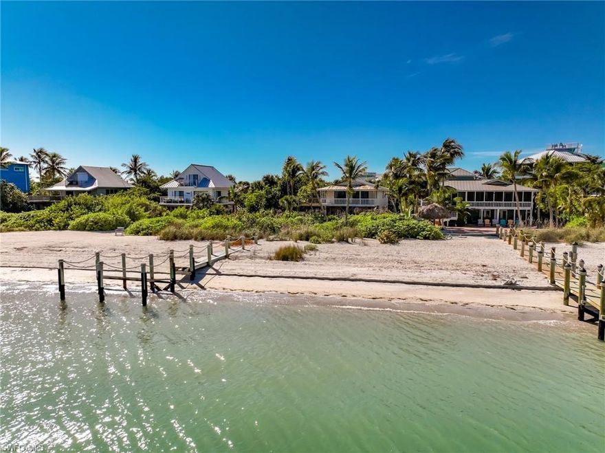Rare Bayfront Fixer Upper!  Impressive panoramic big water views combine with a private sandy bayside beach and the best island fishing right from your dock. This tropical retreat features vaulted ceilings, a cozy fireplace, and light-filled living spaces with a seamless connection to the outdoors, designed for relaxed island living. The heart of the home opens to a large, open porch facing the bay, where gentle breezes, passing boats, and colorful sunrises create the perfect setting for morning coffee and evening gatherings. Overlooking Pine Island Sound, this home offers a rare opportunity to extend the existing wooden dock so you can park your new boat right outside your door. Inside, the open-concept living area is enhanced by soaring ceilings and an airy layout that brings the bay views into everyday life. The open kitchen with a dining bar flows naturally into the main living space, making it ideal for entertaining, casual meals, and easy island living both inside and out. This classic beach cottage fixer-upper is an exceptional blank canvas—a rare chance to personalize and transform a truly special waterfront setting into your dream bayfront retreat. The large adjacent lot located on 130 Mourning Dove Dr is also available for purchase to create extra privacy.  Located on North Captiva Island - a private, boat-access-only barrier island known for pristine beaches, wildlife preserve, and golf-cart-only roads. This low-priced gem is true bayside living at its best—peaceful, scenic, and full of potential.