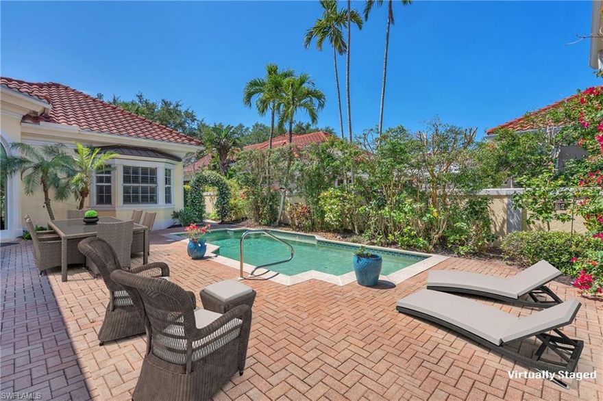 One or more photo(s) has been virtually staged, AI generated or rendered.  Set within one of Pelican Bay’s most exclusive gated enclaves, Isle Verde is nestled within the Pelican Bay golf course and is one of only 38 homes in this small and tranquil community. Residents of Pelican Bay enjoy exclusive access to three miles of private white-sand beaches with chair and umbrella service, beachfront dining, tennis and pickleball, scenic walking and biking paths, and a fully attended fitness center. This property is a short bike or drive from these amenities, and is walkable and bikeable to shopping, groceries, and fine dining. 
 
This 3 Bed, 3.5 Baths villa boasts a number of coveted and unique features. Southwestern exposure fills the private courtyard, pool, and guest “casita” with warm, natural sunlight throughout the day. The entrance is lined with walls of jasmine, opening into a lush tropical courtyard framed by bougainvillea, hibiscus, and swaying palms. Designed for both intimate relaxation and effortless entertaining, this inviting outdoor sanctuary features a heated pool, expansive sun decks, and a seamless indoor-outdoor flow that defines the Naples lifestyle. Another distinct feature is the villa's 28’ x 19’ screened veranda—the first of its kind in Isle Verde. This expansive, breezy retreat is great for morning coffee, sunset cocktails or outdoor dining & entertaining.
Inside the villa, soaring ceilings and newly installed impact-rated doors and transoms create a light-filled, airy ambiance. The living and dining areas feel both elegant and comfortable. The newly remodeled kitchen connects the courtyard through three oversized sliding doors. High-end designer furnishings further elevate the villa's resort-like feel and charm.  
With multiple outdoor living areas—including the courtyard, backyard veranda overlooking the golf course, and the guest casita—this home offers ample living space, privacy, and a true sense of retreat.
The seller has been given permission to share architectural drawings of a neighboring property that added an additional bedroom and bath above the garage with an identical floor plan.