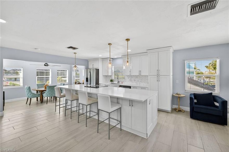 Welcome to paradise! This 2 story canal home with boat dock & 13,000 lb. lift combines convenience and the  Florida lifestyle! Just a 5 minute walk to Gulf & deeded beach access. Your canal delivers direct gulf access right in your backyard! Short walk or bike to Time Square, eliminates traffic, convenient to bars and restaurants but far enough away to avoid crowds. Dock your boat and 2 jet skis right at home at your private boat dock that has water and electric for easy maintenance. . Custom kitchen with quartz countertops in a coastal kitchen blends natural elegance with durability with a 12' long island that can accommodate up to 6 bar stools. 2 bedrooms up with 2 custom bathrooms with duel vanities. Lower level has media area, full bathroom, 3rd bedroom, bar and tons of additional space. Wall of windows overlooking the canal and views of the gulf of America. Large 2 car garage provides plenty of space for cars and storage. A very large backyard that provides the perfect setting for a large pool. Whether you are seeking a vacation retreat, lucrative rental investment, or year-round sanctuary, this home delivers the best of Fort Myers Beach living!