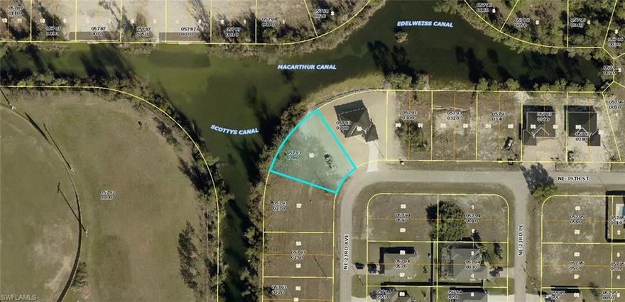 Oversized, pie-shaped RESIDENTIAL building lot with approximately 138 feet of water frontage with intersecting freshwater canal views of both Scotty's Canal and MacArthur Canal.  Fishing and boating can be as close as your own back yard!  The list of positive attributes goes on & on!  NW rear exposure will provide for gorgeous sunsets from your future home, backyard pool and lanai.  Island Coast High School is within walking distance, along with the new and very popular Gator Trails Community Park featuring a playground, pickleball courts, basketball courts, picnic gazebos, walking trail, and dedicated exercise station.  A brand-new Aldi's is being built nearby for convenient grocery shopping!  New construction in the neighborhood makes this a desirable area to build your new home!  THE GOOD NEWS CONTINUES:  No Protected Species and NOT IN A FLOOD ZONE!   This is your chance to purchase a beautiful and optimal spot to build your new home!