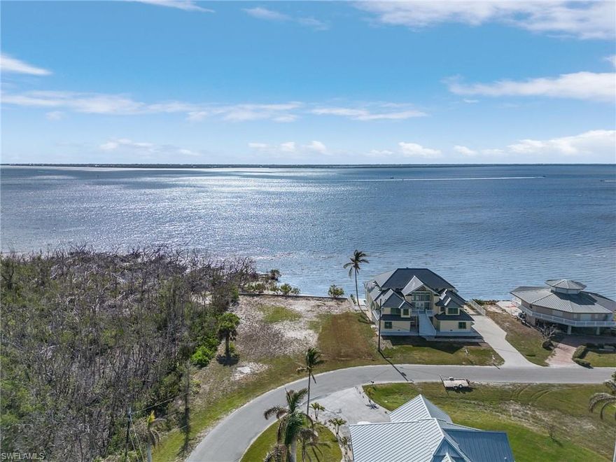 This is one of the few and least expensive bayfront lots left on Pine Island to build your dream home. The stunning, unobstructed views of San Carlos Bay, Sanibel, and the Intracoastal Waterway (ICW) boat traffic will keep you occupied for hours. Enjoy the breathtaking sunrise and sunset views with the southern exposure, while the Ospreys and Bald Eagles fly overhead and the dolphins and manatees play in your backyard. With the quick access to the ICW, Gulf of Mexico, Sanibel, Captiva, Ft. Myers Beach, and all of the Outer Islands of Lee County, you can be fishing in mere minutes. Imagine waking up to the tropical breezes, gathering your fishing gear to head to your private dock on the canal side for some of the best fishing in all of SW Florida. With preserve land on one side, there is lots of privacy in this gated boating community. The HOA fees are low at only $600/year.