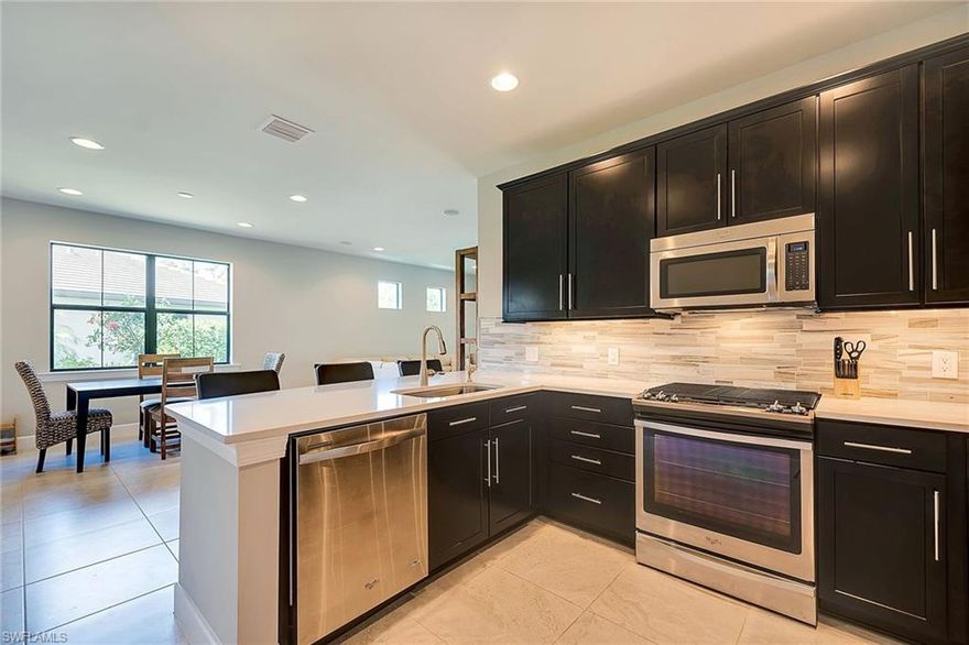 2BR+ Den, "Serenity" villa boasting more than $100K in upgrades with quick possession! Lanai was freshly power washed and sealed. TRUE VALUE that includes maple cabinetry, roll-out drawers, under cabinet lighting, stunning polished back splash, reverse osmosis system, single stainless sink, stainless appliances with natural gas slide-in range. Sparkling quartz counters and desirable built-in closet shelving throughout. Frameless shower door, floor-to-ceiling wall tiles in baths, double sinks in master bath, walk-in closet. Wired for sound with home theater system upgrade, built-in Klipsch speakers in LR & Master. Entertaining is easy on the screened lanai, privacy wall, inviting saltwater pool and spa on private, preserve lot.  2-car garage with epoxy floor. Winding Cypress is appreciated for its active, social lifestyle and world class amenities nestled within 800 acres of natural preserve areas. Stroll over to the state-of-the-art clubhouse, resort-style pool and restaurant. Bike to the preserve boardwalk and if gardening is your passion, there are community gardens. Minutes from beaches, fishing, kayaking and amenities with shopping, dining and cultural attractions.