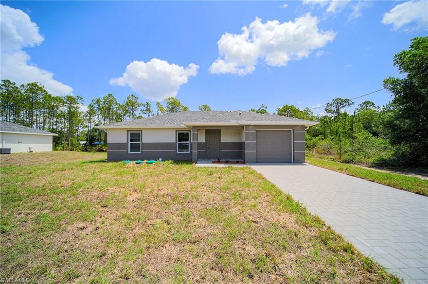 BRAND NEW CONSTRUCTION! You Will Be Amazed By The Quality Of This Brand New 3 Bedroom/2 Bathroom Home With Western Exposure For Those Amazing Florida Sunsets All On An 1/4 Acre Lot In The Beautiful Greenbriar Neighborhood Of Lehigh Acres, FL. This Home Has 1258 SF Under Air And It Is COMPLETELY Finished With Its CO Issued! You Can Move Into It Today Or Use It As A Cash Flowing Rental Unit (High Demand). The Gourmet Kitchen Comes With Quartz Countertops, STAINLESS STEEL APPLIANCES, Real Wood Shaker SOFT TOUCH Cabinet Doors & Drawers, Glass Tile Backsplash, Floor To Ceiling Pantry, And A Large Breakfast Bar. Other Upgrades Include; FREE BRAND NEW WASHER AND DRYER WITH PURCHASE OF THIS PROPERTY, HURRICANE IMPACT WINDOWS AND DOORS, Glass Back Door To Let In More LIGHT, Large Designer Porcelain Tile Flooring Throughout Entire Home, PAVER DRIVEWAY, High Ceilings, Large Living Room, Upgraded Baseboards, Large Dining Area, Custom Interior/Exterior Two-Tone Paint, Custom Ceiling Fans/Lights, Large Walk-In Closets, Quartz Countertops In The Bathrooms Along With Accent Tile Over The Tub Areas, New Landscaping Package, Northeastern Exposure For Those Beautiful Florida Sunrises/Sunsets, Epoxy Coating In The Garage And On The Open Covered Lania, Huge Back Yard Surrounded By Woods And Pine Trees, And A Laundry Area Including A New Washer And Dryer Inside The Home. This Home Is Close To Regional Shopping Malls, Golf Courses, Interstate I-75, Regional Airport, FGCU, Restaurants, Schools, Golf Courses, MLB Spring Training Baseball, Outdoor Parks, Boat Ramps, Amazing Fishing, And Those Amazing White Sand Beaches Of The Gulf Of America!