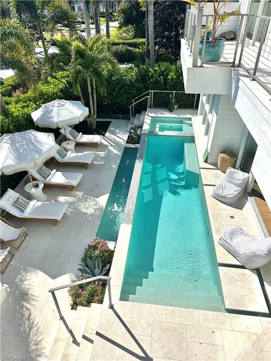 This exquisite 4 bedroom, 5 bathroom coastal contemporary home is perfectly situated just blocks from Naples’ white sand beaches and the vibrant Third Street South and Fifth Avenue districts. Built in 2022, the 4,600-square-foot retreat blends modern luxury with sophisticated design. The gourmet kitchen features Wolf/Sub-Zero appliances, dual refrigerators, a wine tower, and a Cristallo quartzite island, complemented by a butler’s pantry with a second dishwasher. The open-concept layout flows seamlessly from kitchen to living and dining, filled with natural light and enhanced by a Sonos sound system. An air-conditioned lounge with fireplace and folding doors overlooks the outdoor oasis. The first-floor primary suite with king bed offers a spa-like marble bath and generous closet space, while upstairs a second primary suite includes a private balcony. Two additional en suite king bedrooms and an upper-level lounge provide comfort for guests. Outdoors, enjoy a 35-foot heated pool and spa, water feature, dining area, and four-season room with wet bar. Additional features include dual laundry rooms, a full-house generator, air-conditioned 2-car garage, beach and pool gear, security system, and spacious circular driveway. Live exceptionally in Olde Naples!