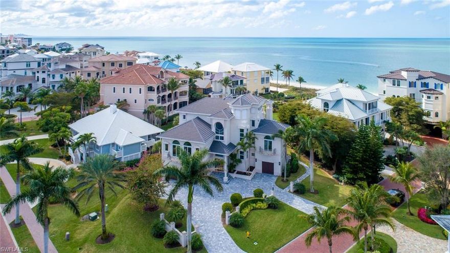 Spectacular Barefoot Beach estate on an ultra-rare DOUBLE LOT with a breathtaking Gulf of Mexico setting & coveted Southwest exposure. Boasts an extra-wide view (courtesy of double lot) of the turquoise Gulf waters & sugar sands of Barefoot Beach with ample outdoor living space. This home is beautifully renovated in a coastal contemporary motif including gorgeous stone & hardwood floors, designer light fixtures & a white/gray chef’s kitchen with quartz counters & upgraded professional-grade appliances. Features a new 2017 roof, full storm protection (impact glass, electric & manual storm shutters), private elevator & Leviton smart home system controlling climate, lighting & security system with cameras. Fantastic floor plan with bonus/flex spaces on the main room & ground floor, oversized master suite with private balcony, 2nd laundry & 2 sitting areas/den spaces. Barefoot residents enjoy a clubhouse with tennis & fitness center, 3 miles of beachfront & manned gate. The OPTIONAL “Club at Barefoot” offers boat slips, tennis, 2 restaurants, private pool & beachside food/beverage/chair service. Prime Collier County location minutes to Mercato, Waterside & easy access to RSW.