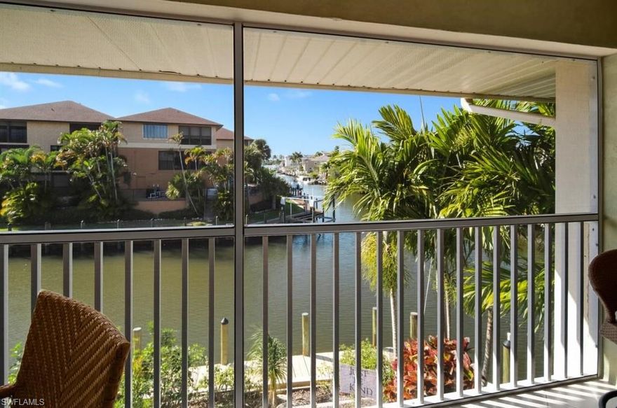 BOATER'S DREAM!! GORGEOUS WESTERN VIEW OVERLOOKING INTERSECTING CANALS, PEEK AT THE BAY AND WATERSIDE LIGHTS.  COMPLETELY REMODELED CONDO W, 20" TILES THROUGHOUT, WARM WOOD CABINETS AND UPGRADED GRANITE, STAINLESS, ACCENT LIGHTING IN THE KITCHEN, BOTH BATHS REMODELED WITH UPDATED TILES AND GRANITE, CROWN MOLDING, IMPACT WINDOWS AND SLIDER!!!   SPACIOUS LANAI OVERLOOKING THE CANAL AND BAY WITH SUNSET VIEWS.  ALSO INCLUDES 27 FOOT BOAT DOCK WITH EASY IN/OUT, WHIPS AND DECKBOX.  JUST STEPS TO THE POOL, AND MINUTES TO 5TH AVENUE.  VERY DIFFICULT TO FIND THIS KIND OF VIEW ON A CANAL FRONT CONDO.  SOLD TURNKEY FURNISHED WITH QUALITY PIECES, SO JUST BRING YOUR SUITCASE AND START LIVING THE WATERFRONT LIFESTYLE IN FLORIDA'S PARADISE.