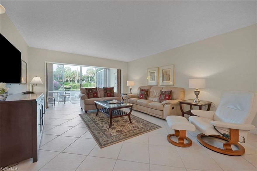 Enjoy easy Southwest Florida living in this first-floor, 2-bedroom, 2-bath end-unit residence in the Montego Manor community within Palm River. Offering approximately 1,269 square feet, the split-bedroom floor plan provides privacy and comfortable living space. The light-filled interior features a spacious great room, a versatile Florida room with views of the landscaped grounds and community pool, and an eat-in kitchen with ample cabinetry. The primary suite includes dual sinks and a walk-in shower, with a well-positioned guest bedroom and bath. Additional features include in-residence laundry, a detached carport, and guest parking. Montego Manor is a non-gated 55+ community with a community pool and included cable, water, sewer, lawn care, and building insurance. An excellent option for a low-maintenance vacation property or income-producing investment, conveniently located west of I-75 near shopping, dining, and North Naples beaches.