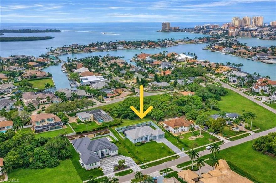 LOWEST PRICED NEWER CONSTRUCTION SINGLE FAMILY HOME ON HALF ACRE LOT IN MARCO ISLAND! Exquisite Coastal Estate – Steps from the Gulf, Half-Acre Lot, and Fully Customized. This stunning 4-bedroom plus den, 3-car garage residence sits on a rare half-acre homesite in one of the most exclusive estate neighborhoods near Marco Island—just steps from the shimmering waters of the Gulf. Caxabas & San Marco Marina are just minutes away! Built with elevated design and having sustained no hurricane damage, this home offers the perfect blend of safety, sophistication, and seaside luxury. Inside, you’ll find soaring vaulted ceilings and a bright, coastal-inspired interior that’s filled with natural light. Wide-plank tile flooring runs throughout, anchoring an open layout that flows effortlessly from the living area to the dining area to the entertaining space. The custom kitchen is a chef’s dream, complete with quartz countertops, sleek white cabinetry, double wall ovens, and a large island perfect for gathering. A built-in wet bar adds a touch of elegance, ideal for hosting or everyday enjoyment. Glass sliders open to an expansive covered lanai, where an outdoor kitchen, TV lounge, and a custom-designed pool and spa with elegant water features create your own private resort. A 500-gallon underground propane tank fuels the built-in BBQ & generator. The oversized yard is beautifully landscaped, offering space and privacy rarely found this close to the Gulf. The primary suite is a true retreat, featuring direct access to the outdoor living space, dual walk-in closets, and a luxurious spa-style bathroom with a glass-enclosed walk-in shower and a dramatic freestanding soaking tub. A dedicated home office with large windows provides inspiring views and abundant natural light, making it a productive and peaceful workspace. This is a rare opportunity to own in a high-end coastal enclave with no HOA restrictions, quick access to the open Gulf waters, and every feature today’s buyers are looking for. Whether you’re seeking a full-time residence or a high-performing rental investment, this home delivers on all fronts — location, design, and lifestyle.