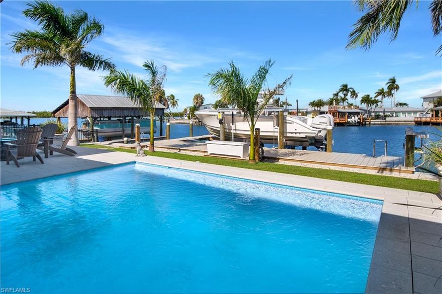 If serenity, sunshine, and sea life sound like your kind of daily routine, this property is calling your name. Welcome to your waterfront escape on the beautiful Isles of Capri! This charming three-bedroom, three-bathroom home offers the ultimate blend of tranquility, nature, and direct access to all the Gulf of America has to offer. Nestled along Marlin Bay, which is this island’s only man-made bay, you'll enjoy the rare privilege of larger docks and boat lifts than anywhere else in the area. Inside, the home offers comfort and functionality with three well-appointed bathrooms and a layout ideal for entertaining or relaxing after a day in the sun. The primary bedroom provides a private retreat, while the other two bedrooms give ample space for guests or hobbies, think of it as your very own sunshine-fueled sleepover headquarters. Tile flooring stretches throughout the entire home while the Hurricane Impact windows and sliders provide peace of mind that blends with panoramic water views. Outside, everything you want from Florida living starts with the environment itself. Situated within Rookery Bay, a protected and towering ecological gem, wildlife sightings are part of the deal as dolphins and manatees are regular performers. And when they take a break, you’re just minutes away from natural wonders like Keewaydin Island and Cape Romano. Bring your sunscreen and your sense of adventure because this location is the perfect launching point for exploration. Whether you’re an offshore fishing aficionado, a paddleboarding enthusiast, or someone who simply enjoys a front-row seat to nature, this home caters to your coastal lifestyle, with wildlife always just a glance away. When you're not on the water, you'll want to be in the spacious, concrete swimming pool, enjoying views of dolphins and manatees. Yes, that splash in the bay might just be another finned neighbor coming by to say hello. Living here often feels like flipping through a National Geographic magazine, only better because it’s real and right outside your door. The Isles of Capri offers a laid-back, nature-loving lifestyle with a touch of old Florida charm. Located just one mile from the shopping and restaurants of Marco Island and only twenty minutes from the elegance and fine dining of downtown Naples, you’ll enjoy a peaceful retreat without sacrificing everyday convenience. Four neighborhood restaurants, each with its own coastal flair and three marinas add to the ease of living on the island. So, whether you’re watching the wildlife from your pool, setting out for a Gulf sunset cruise, or simply breathing in the salty breeze, every day here offers a postcard-worthy backdrop. If you're looking to swap fast-paced living for slow sips by the bay, this is your place to unwind, recharge, and enjoy the water at your own pace. Welcome to paradise, Welcome to Isles of Capri!