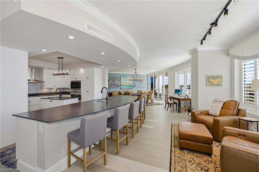 Exceptional end-unit residence in the newer tower at Aqua at Pelican Isle, ideally positioned with southwest exposure and beautiful views of the marina, and inland waterways out front, plus golf course views to the rear. With a wall of windows and doors natural light is in abundance.   Two separate lanais with sliding doors, allows this residence to capture both sunrise and sunsets along with refreshing coastal breezes. One of only a few with built in BBQ on the lanai.

The spacious floorplan offers 3 bedrooms plus a large den and features two distinct living areas, creating flexibility for entertaining and comfortable everyday living. Natural light pours in from the additional side windows unique to an end residence, enhancing the open feel throughout.

The gourmet kitchen is thoughtfully appointed with a natural gas cooktop, built-in ice machine, oversized island, and generous cabinetry—ideal for both casual dining and hosting. The primary suite is a private retreat with an exceptionally large spa-style bath and expansive closets. Guest bedrooms provide comfort and privacy for family and visitors.

Aqua is a boutique luxury building with only 32 residences in the second tower and an unmatched amenity package designed to elevate your lifestyle. Enjoy direct Gulf access through Wiggins Pass from the private marina, a state-of-the-art fitness center, spa, resort-style waterfront pool, theater, game room, sky lounge, and sunset terrace. Additional highlights include a golf simulator, putting green, dog park, multiple guest suites, with concierge services and 24/7 security.