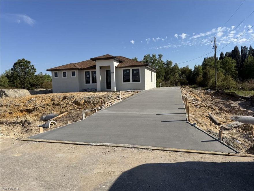 This new construction home is perfectly situated in the Lehigh Acres area, just off Joel BLVD. Enjoy the convenience of nearby shopping, including a Publix and Walmart only 15 minutes away. The property offers excellent accessibility. Modern 1/4 Acre New Construction 3 Bed + Office / Modern Style + Land + Incentive! / Quartz Waterfall Kitchen / 2k Credit