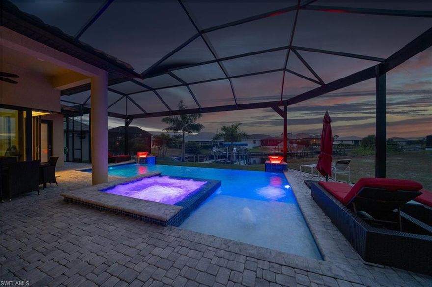 Welcome to waterfront living the way it was meant to be experienced—open, effortless, and deeply connected to the Florida lifestyle. This Gulf-access residence sits on an oversized corner lot and features an inviting infinity edge pool.

The moment you step inside, the space pulls you in with 10 and 12-foot tray ceilings and corner sliders that turned the living area into a breezy extension of the lanai creating seamless indoor outdoor living. The fully automated heated saltwater pool and spa create a resort experience you can enjoy every day.

On demand gas water heater and gas connection on lanai for BBQ grill. 

For the boater, life gets even better. The canal offers Gulf access, and the 12,000-pound lift is ready for everything from sunset cruises to weekend island hopping.

Inside the home, the atmosphere is modern, refined, and quietly luxurious. The Gourmet kitchen blends gas cooking with upgraded appliances with pot filler and smart-home convenience, while the master suite feels like a private spa—complete with floor-to-ceiling tile, dual walk-in closets, an oversized shower with multiple heads and sprayers, and a bidet.

The three-car garage is air-conditioned and finished like a true extension of the home, perfect for hobbyists, storage, or a workshop. And with a whole-house generator, hurricane-impact windows and doors, a 500-gallon owned propane tank, and full smart automation, peace of mind is built into the lifestyle.

Every detail has been elevated to make daily living simple, comfortable, and elevated. Even the window treatments are automated, blackout-only where you want privacy, and tinted where you want efficiency.

A few of the many thoughtful upgrades include:
• Whole-house reverse osmosis
• Newer upgraded appliances
• Outdoor hot/cold shower
• Lanai prewired and plumbed for outdoor kitchen
• Insulated garage doors, epoxy floor, and mini-split A/C
• Upgraded WiFi sprinkler controller
• Modern picture-window pool cage