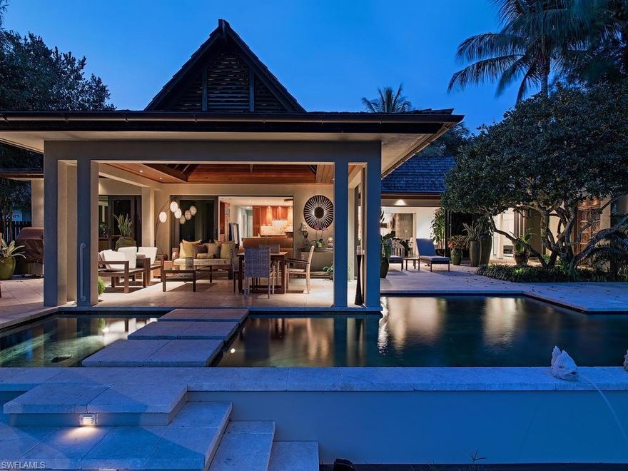 H.11340 - A private realm of timelessness and tranquility, this Aqualane Shores home masterfully blends classic Balinese architecture with a clean lined contemporary interior to create a one-of-a-kind home that is dripping with style.  Cedar Shake roof, copper architectural gutters and lush tropical landscaping frame the front elevation.  The interior finish is defined by sleek clean lines and a minimalist approach with strong accent materials.  Features include large, slate tile flooring throughout, wood beam and tongue & groove ceiling detail, gorgeous custom lighting chandeliers, custom cabinetry and wood work and much more.  Kitchen includes granite countertops, ample counterspace, beautiful cabinetry, large island and double wall ovens. The open lanai is a resort like escape with tiki bar, covered gazebo with intricate wood beamed tongue and groove ceiling detail, custom pool/spa with floating stone steps that lead down to the large wood dock with boat slip and two boat lifts. This is a home that its sum is greater than its parts and must be seen to be truly appreciated.