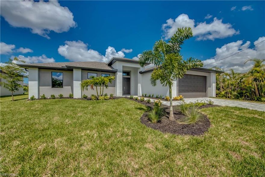 NEW CONSTRUCTION - JUST COMPLETED! This 4 Bedroom, 3 Bath, 2 Car Garage home comes with all the Bells and Whistles. Home is 2,010 sq ft under air with a total of 3,998 sq ft when you include your 1,402 sq ft lanai with an oversized pool and located on a freshwater canal! The Kitchen has been decked out with 42" All Wood Cabinets, Stainless Steel Appliances, Upgraded Countertops, and a huge Kitchen Island. Designer plank tile flooring installed throughout the home including the bedrooms. This home has a Paver driveway, Paver pool deck, complete landscape package with sprinkler system and flora tan sod. The interior specs are 12’ Ceiling in living area, 8' doors, 5 1/4" Baseboard with 3 1/4" Casings, Soffit lighting outside, Frameless Glass Shower Enclosure, Stand Alone tub in the master bath, Trey Ceilings in the living room and master bedroom, pendant lighting in the kitchen, pool bath and so much more. This home is located in the desirable SW section of Cape Coral and comes with a 1 year builder warranty