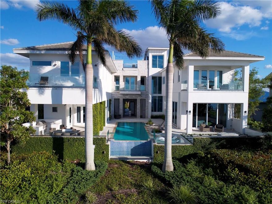 A striking waterfront masterpiece combines clean lines, luxurious, contemporary spaces and maximum comfort. This unique, 6400-square-foot, four-bedroom, recently built residence offers a spacious design and gorgeous entertaining areas ideally separated into comfort zones that offer panoramic views throughout. The home’s interior is elegant and stylish with walls of glass, limestone flooring, LED lighting, stone wall accents, quartz countertops, beautiful cabinetry, custom built-ins, and a state-of-the-art Control4 Home Automation system. Enjoy outdoor living with beautiful river views from open-air decks, a negative-edge pool, outdoor fireplace, rooftop sundeck, deep-water dock, enchanting breezeways, beautiful landscaping, and four-car garage. A home that says “Wow!” to anyone searching for a high-caliber property.