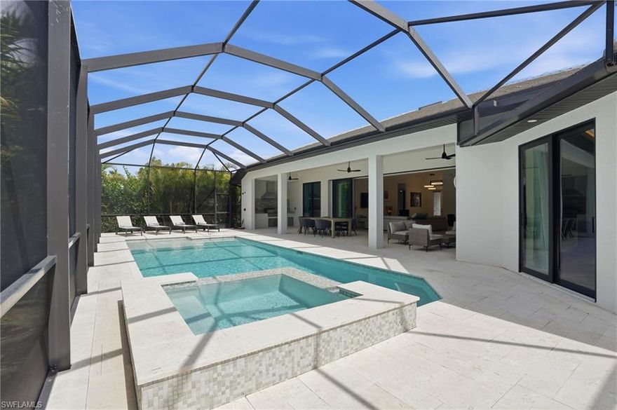 WOW! Sold Turnkey! Just bring your toothbrush!! Experience exceptional design and craftsmanship in this beautifully constructed custom home located in one of Southwest Cape Coral’s most desirable neighborhoods. Ideally situated just minutes from the waterfront lifestyle, fine dining, and boutique shopping at Cape Harbour and Tarpon Point Marina, this newly built home offers both luxury and convenience. The home features four spacious bedrooms and two bathrooms. At the center of the home is a stunning gourmet kitchen designed to impress, showcasing a level-5 quartz waterfall island, striking marble backsplash, custom cabinetry, and premium built-in KitchenAid appliances, including a cooktop. The open-concept great room creates a seamless flow to the outdoor living area, making the home perfect for entertaining.
Step outside to the expansive pool/hot tub and pool area with a screened lanai and large under roof sitting area and a fully equipped outdoor kitchen with a Blaze grill and commercial hood makes hosting effortless. Relax by the electric fireplace or unwind while enjoying breathtaking western sunsets from your private backyard retreat.
The outdoor space is designed for resort-style living, featuring a heated pool and spa surrounded by beautiful White Turkish Shell Stone pavers and lush tropical landscaping that provides exceptional privacy. Whether you’re relaxing in the spa, entertaining guests, or enjoying quiet evenings outdoors, this space offers the ultimate Florida lifestyle.
Designed for durability and style, the home features solid concrete block construction, impact-resistant windows and doors, and decorative metal awnings that enhance its West Indies-inspired architecture. Additional highlights include a three-car garage with epoxy flooring, an oversized laundry room, a walk-in pantry, and designer lighting throughout.
For added peace of mind, the property has never experienced hurricane-related water intrusion.
Whether you’re searching for a full-time residence, seasonal escape, or investment opportunity, this beautifully designed home offers an incredible opportunity to enjoy the best of life in Cape Coral.