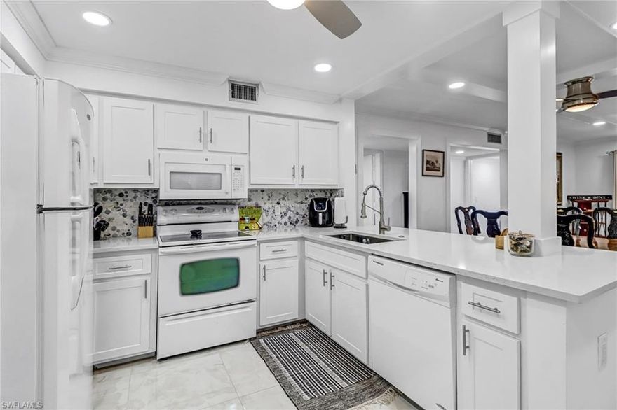 Introducing this Turnkey 2/2 condo in highly sought after Foxfire Golf & Country Club! This recently remodeled unit boasts a modern design, with great finishes and golf course views. Step inside and be greeted by an open-concept living area that is perfect for entertaining guests or enjoying quiet nights in. The spacious living area features tile floors throughout, plenty of light and an impact sliding door that leads to a private screened lanai. This cook's kitchen is sleek with quartz countertops, backsplash & updated cabinetry. The master is a cozy retreat with a walk in closet and en-suite bathroom with updated vanity, shower & modern fixtures. The guest bedroom has 2 twins and easy access to the guest bathroom that has been updated with a modern design. There is a full size washer & dryer, newer a/c 2021, designated parking, a storage closet on the screened in lanai and access to the community's amenities, including 27 holes of golf, tennis plus bocce courts, a fitness center & clubhouse with restaurant and bar . Don't miss out on this opportunity to own a turnkey condo in one of Naples' most sought-after communities less than 5 miles to downtown & the beaches.