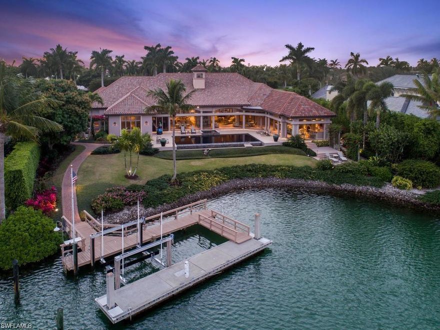 Gorgeous five-bedroom plus den home with spectacular views over Man of War Cove in sought after Port Royal! The open floor plan with split bedrooms provides effortless living with gracious living room with wet bar, elegant formal dining room and formal living room. The gourmet kitchen features custom cabinetry, Sub Zero side by side refrigerator/freezer, Miele appliances: gas range, indoor grill, double oven, warming tray. The master retreat features a private entry to outside sitting area and dual master bathrooms. The remaining four-bedroom are large and feature en-suite bathrooms. Residence is completed with generously sized covered outdoor patio area and landscaped back yard, which is perfect for outdoor entertaining, expansive lanais with electric screens & shutters, floating concrete 40' boat dock and lift, infinity edge pool and/spa, 3 car air-conditioned garage & Generator. Port Royal Membership Eligibility.