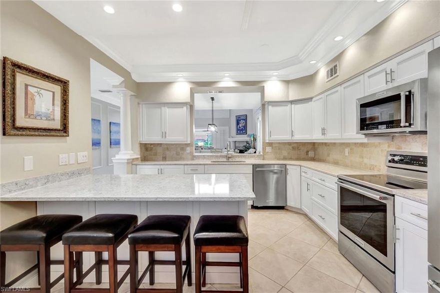 Spanning 2,900 square feet, this extensively upgraded Aberdeen floorplan stands out as one of the best values in Naples, delivering exceptional accommodations with four bedrooms, two and a half bathrooms, and a private pool set against serene lake and golf course views. At the heart of the home is a fully reimagined kitchen, thoughtfully designed with all new cabinetry, a custom quartz island, Red Medallion Series KitchenAid appliances, built in organizers, and refined finishes that balance beauty and function. The open layout flows effortlessly to the outdoor living area, where a paver lanai and saltwater pool, enhanced by new pool equipment in 2022, offer a relaxing setting for morning coffee, laid back afternoons, and evening entertaining. For peace of mind and year round comfort, the home is equipped with electric storm shutters, a new A/C system installed in 2023, and a private, secondary irrigation system serving the front entry courtyard. Upstairs, a rarely found 8' x 10' bonus room adds valuable storage or flexible space, while the thoughtful separation of bedrooms provides excellent privacy for guests and family alike. The great room makes a striking impression with soaring 20 foot ceilings and elegant architectural detailing, including crown molding, custom wall framing, and a wood burning fireplace. A 2.5 car/golf cart garage easily fits two vehicles and a personal cart. Residents enjoy an Equity Social Membership to the Quail Village Golf Club, included with HOA fees, which provides access to the newly renovated restaurant, community pool, unlimited summer golf, six rounds in season, tennis, pickleball, bocce, and more. Full Golf Memberships are optional and available for those seeking year round play. As the largest floorplan in the community, this move in ready home delivers scale, upgrades, and a lifestyle ready for its next owners to enjoy.