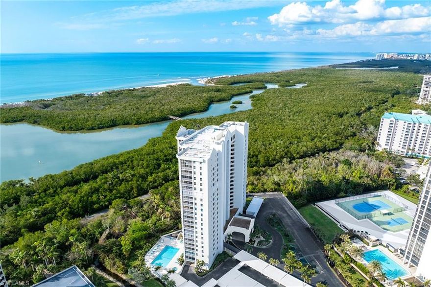 Welcome to St. Nicole in Pelican Bay, where refined coastal living meets one of Naples’ most amenity-rich beachfront communities. Positioned on the 16th floor, this rare south-end residence captures extraordinary 270-degree vistas—a distinctive feature not found in many end units—offering sweeping views of Clam Pass, the Gulf and the Pelican Bay landscape. This turnkey, elegantly updated two-bedroom plus den, two-bath residence is filled with natural light and designed for effortless living. The enclosed lanai adds approximately 155 square feet of interior living space, creating an ideal setting to enjoy stunning western sunsets. The flexible floor plan allows the den to be easily converted back to a third bedroom if desired. Interior highlights include three custom California walk-in closets, advanced window treatments, custom motorized solar shades, designer louver shutters in the bedrooms and expansive floor-to-ceiling mirrors that enhance light and space throughout the home. The residence also features in-unit washer and dryer, additional storage and thoughtful finishes throughout. St. Nicole is an intimate enclave of only 97 residences on the desirable southern end of Pelican Bay, offering a private callbox for secured tram access just steps from the building. Residents enjoy private beachfront access with chair and umbrella service, two beachfront dining venues, tennis, pickleball, fitness and wellness facilities, sailing, kayaking and miles of scenic nature trails. Currently undergoing comprehensive building enhancements, St. Nicole continues to elevate its design, amenities and long-term value within Pelican Bay’s premier coastal lifestyle.