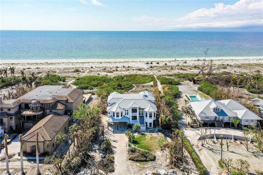 Expansive Gulf of Mexico views from this Sanibel beachfront home. Located in one of Sanibel’s most charming communities, this home sits on

over an acre and offers 4 bedrooms, a separate office/den, 5.5 baths and large open porches off the living room and master bedroom. Views of the beach and the Gulf can be seen from almost every room in the house. The living room has a high vaulted ceiling with glass sliders opening out to the porch providing an abundance of light. White tile floors throughout and a fireplace built into a beautiful white stone wall add to the open and airy feel of this great room. The large kitchen with an eat in breakfast area and walk in pantry opens to the great room for easy entertaining. Easily accessible by an elevator, the master bedroom on the upper floor has a beautiful open porch as well from which one can view the sunsets and beach for miles. The windows have been replaced with Dade County standard windows and sustained no damage. The roof was new in 2019 and suffered no leaks from the storm.  Only the ground floor had water intrusion.
