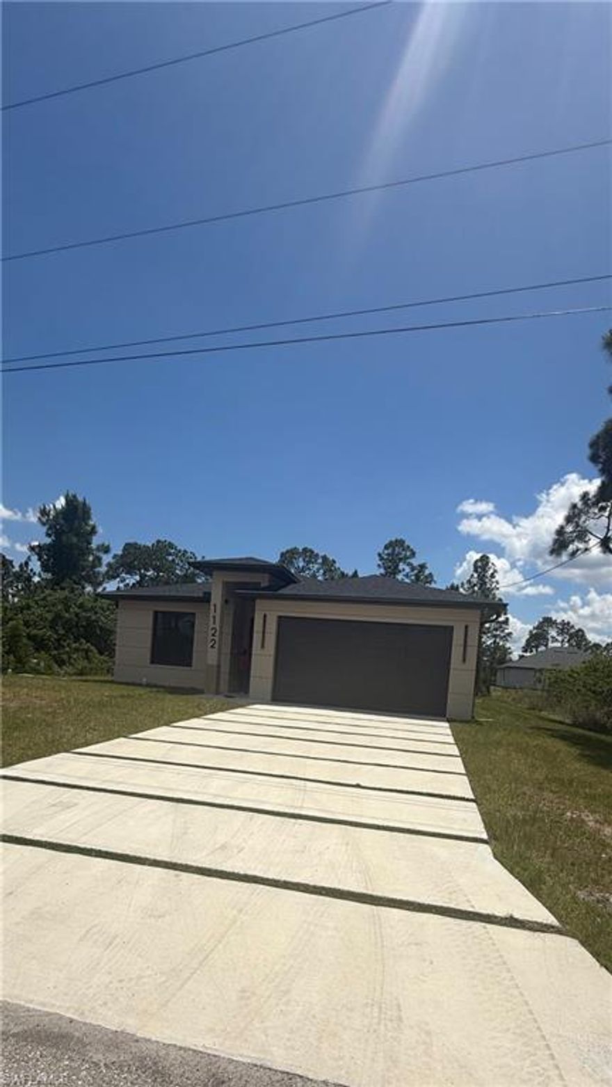 One or more photo(s) has been virtually staged, AI generated or rendered.  Excellent opportunity! Brand-new construction featuring 3 bedrooms and 2 bathrooms in a central Lehigh Acres location.