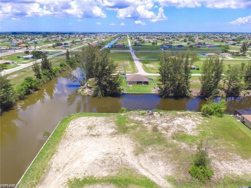 235 FEET OF WATERFRONT........OVERSIZED WATERFRONT LOT WITH A TRUE INTERSECTING CANAL VIEW!!!!! Freshwater Access To Eight Area Lakes And Miles Of Canals.....Minutes To Diplomat. Close to Pine Island Corridor.