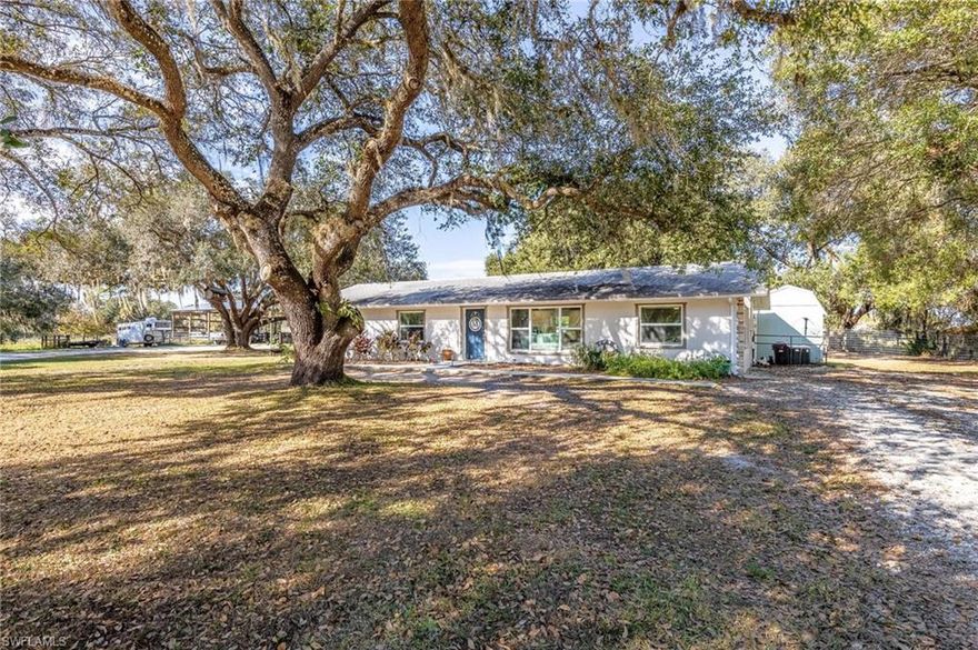 This rare country estate is fully fenced and on 5+ acres of pristine land. Nature lovers will fall-in-love with this peaceful retreat framed by ancient oak trees providing wonderful shady areas, cool breezes, and wide-open spaces. The 3-bedroom, 2-bathroom home with a new and large horse/pole barn offers privacy, and the dramatic sunsets are free! The home features a newly remodeled kitchen with quartz countertops and recessed lighting, new wood flooring throughout the home, new impact windows throughout, new AC system, new blown-in attic insulation and more! Bee Branch Lakes is one of the most sought-after areas in the growing area of Labelle, offering oversized lots and plenty of space for all of your grown-up toys, hobbies and farming goals. No HOA fees, makes this child and pet friendly oasis an appealing place to put down roots and live approximately an hour to white sandy beaches. This is truly a one-of-a-kind property. Call today and make it yours to brag about, while taking advantage of today's record-breaking low interest rates!