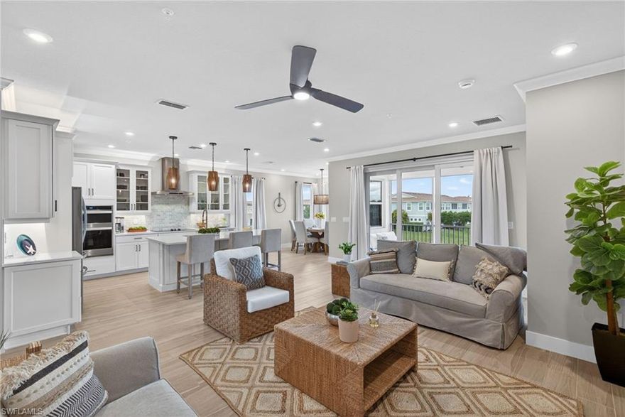 Set against sweeping panoramic lake views, this beautifully and fully upgraded better than new end-unit residence offers one of the most enhanced homes within the community. The two-story Oceangrove floor plan features three bedrooms, two full baths, and a two-car attached garage, combining modern design with thoughtful functionality in the vibrant Bayshore Arts District—just minutes from downtown Naples and the Gulf’s white-sand beaches.  

The open-concept interior is filled with natural light and finished in a coastal contemporary style, highlighted by beautiful wood-look tile flooring throughout the main living areas. At the heart of the home is a chef-inspired eat-in kitchen featuring white shaker cabinetry, quartz countertops, upgraded appliances including glass front refrigerator, Carrara marble backsplash, an oversized island ideal for entertaining, and a spacious walk-in pantry. The dining area and lanai both overlook the tranquil lake, creating an ideal setting for everyday living or relaxed gatherings. Endless upgrades including crown molding, hardwood interior stairs, upgraded light fixtures and ceiling fans throughout. 

Smart-home features enhance convenience and security, including Wi-Fi–enabled appliances, a smart thermostat, electronic door lock, whole-house surge protection, and a Ring security system. The home also includes an impressive 85-inch Samsung smart TV. A full-size laundry room with upgraded side-by-side washer and dryer provides additional storage and functionality.

As an end unit, the home enjoys abundant natural light along with a lanai that captures expansive lake views plus a wall-mounted TV.  The two-car garage features an epoxy floor.

Residents enjoy access to community amenities including a pool and fitness center. The low HOA fee adds exceptional value and includes high-speed internet, water, sewer, landscaping, and exterior building insurance—making this an ideal full-time residence or seasonal retreat in one of Naples’ fastest-growing and most creative districts. An easy walk or bike right to Naples Pickleball center and Naples Botanical Garden.

Offered turnkey furnished with $50k+ worth of furnishings.  Originally the lot premium was $89k.  Truly the most exceptional home in the community.