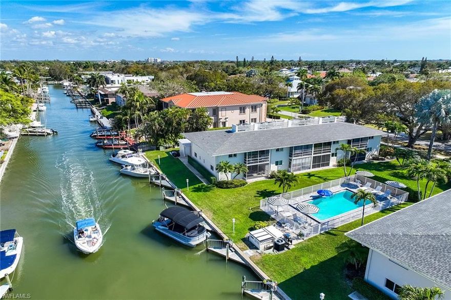 Enjoy serene Royal Harbor waterfront living where sparkling canal views, passing boats, and modern design create an exceptional Naples coastal retreat just minutes from Old Naples world-class beaches, shopping and dining. Set along a scenic canal in prestigious Royal Harbor, this beautifully reimagined residence delivers refined waterfront living with tranquil views and exceptional upgrades. Extensively remodeled, the light-filled interior showcases impact glass windows, fresh paint, and a stunning new kitchen featuring quality cabinetry, stainless appliances and quartz countertops. Porcelain tile flows seamlessly through the residence, complemented by designer light fixtures that enhance the home’s clean, contemporary aesthetic. Renovated baths and thoughtfully curated finishes create a sophisticated, low-maintenance environment for a move-in ready experience. Ideally in a desired corner location closest to the canal, the residence enjoys additional end-unit windows that fill the home with natural light and enhance its bright, airy atmosphere. The thoughtfully designed floor plan includes two spacious bedrooms and two fully renovated baths, with quartz surfaces carried throughout for a cohesive and refined finish. A designated parking space and private storage room provide added convenience, offering ideal space for beach equipment, bicycles and recreational gear. Exterior updates have recently been completed to enhance the property’s appeal as the ultimate coastal retreat. Outdoors, Chesapeake Manor enjoys a tranquil waterfront setting where an angled canal view creates an ever-changing backdrop of sparkling water and passing boats. The screened, under-roof lanai overlooks the pool and canal, creating a setting for sparkling, sunny afternoons. Residents can watch the boats glide by, fish from the seawall, or relax beside the beautiful sunny pool and lounging deck with umbrellas. The outdoor living space is enhanced by a private courtyard atmosphere and lush landscaping, creating a serene setting for quiet enjoyment and effortless entertaining. Chesapeake Manor is a private, low-density waterfront enclave with just 16 residences, offering an intimate coastal lifestyle in one of Naples desirable locations. Royal Harbor is one of Naples desirable waterfront neighborhoods, ideally just minutes from downtown’s renowned 5th Avenue South and 3rd Street South districts, offering world-class dining, shopping and white sand Gulf beaches. Residents enjoy a relaxed coastal lifestyle with boating access, quiet residential streets, and exceptional proximity to Naples’ cultural and social amenities. Whether for a weekend retreat for Naples residents or travelers from afar, or an exceptional opportunity to enjoy full-time waterfront living, this residence presents a rare opportunity to experience Naples lifestyle with the ease, beauty and peace of mind of extensive modern updates.