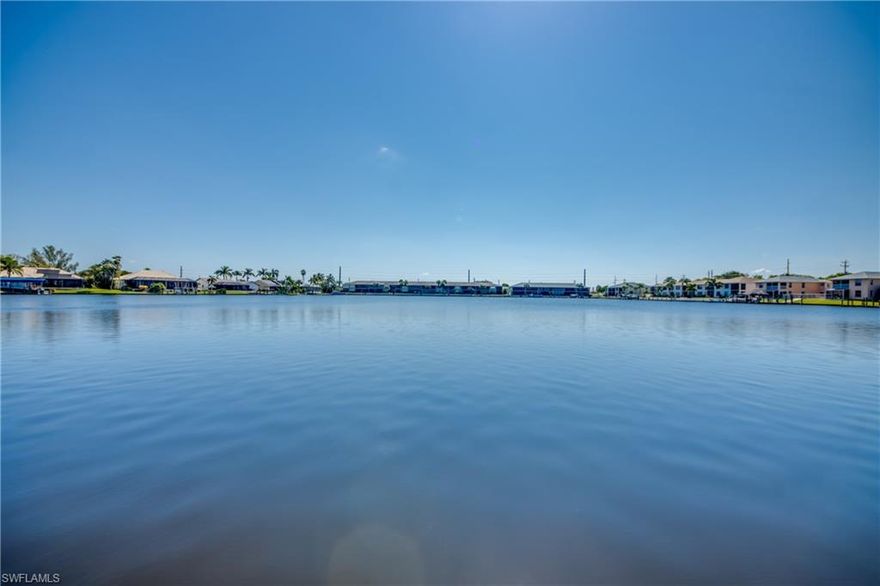 << MULTIPLE OFFERS >> Some waterfront homes impress. Others quietly capture your heart. Set along the legendary waters of LAKE LOUISE, this property offers wide, cinematic lake views, unforgettable SUNRISES and a way of life centered on boating, fishing and time well spent with the people who matter most. There is something enduring about this setting—peaceful, nostalgic and timeless—evoking the feeling of an On Golden Pond moment right here in Cape Coral. This is WATERFRONT living at its finest, where the golden rule of real estate—LOCATION, LOCATION, LOCATION—takes center stage. From your backyard, enjoy sweeping lake vistas with true GULF ACCESS, a rare combination of scale, beauty and value that is increasingly hard to find. The home sits on an OVERSIZED LOT with an impressive 98 FEET OF SEAWALL, offering both presence and possibility. Eastern exposure brings glowing morning light across the water, while the lanai stays shaded and comfortable through the afternoon, creating an ideal balance for outdoor living. Whether it’s quiet mornings with coffee or relaxed evenings cruising the lake with friends, this home is designed for making memories. Inside, the layout blends comfort and function with thoughtful updates throughout. The UPDATED KITCHEN features bisque cabinetry with crown molding, soft-close drawers, granite countertops, stainless steel appliances, backsplash and pantry storage. A split-bedroom floor plan provides privacy for the MASTER SUITE, highlighted by a UPDATED BATH with white raised-panel cabinetry, dual sinks and granite counters. Two guest bedrooms both with WALK-IN CLOSETS and the guest bath also serves as a convenient POOL BATH. Three large POCKETING SLIDERS create an easy connection between indoor and outdoor spaces, allowing the pool and lanai to feel like a natural extension of the living area. An oversized laundry room with washer, dryer and cabinetry adds everyday practicality. Outdoors, the SALTWATER POOL takes center stage, resurfaced in 2022 and enclosed by a dramatic PICTURE-SCREEN CAGE that frames the lake as living artwork. The spacious under-truss lanai offers room for dining and lounging, while the PAVERED deck flows effortlessly toward the WATERFRONT. A concrete dock and a wood dock with boat lift (in need of repair) provide access to open Gulf waters, making boating, fishing and island hopping part of daily life. The dimensional shingle roof was replaced in 2019, and the home is being sold FURNISHED, making it truly MOVE-IN READY. By boat or car, you’re just minutes from FORT MYERS BEACH and SANIBEL, known for sugar-sand beaches, waterfront dining, and world-class shelling. The INTERNATIONAL AIRPORT, shopping, dining, golf and year-round activities are all conveniently close. With gentle breezes off the lake, golden SUNRISES to start the da, and endless opportunities to gather and unwind, this home offers more than a place to live—it offers a place in time set on one of Cape Coral’s most extraordinary lakes.