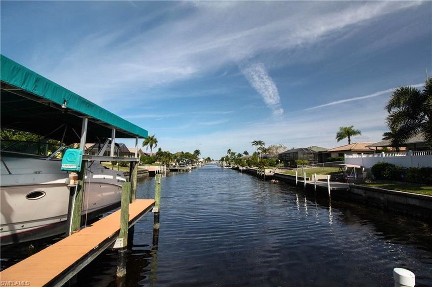 PRICE REDUCED!! BOATER'S PARADISE!! This SAILBOAT ACCESS pool home is ready for new owners!! NO BRIDGES and one right turn will take you right out to the Caloosahatchee River!! Lounge in your electric heated pool and enjoy the breathtaking view which spans the ENTIRE length of the Rodney Canal~You won't see into your neighbor's backyard from here! This home features a chef's kitchen updated in 2014, complete with a Jenn-Air induction cook top and oven, stainless steel appliances, Quartz countertops, and all wood cabinetry with soft close drawers and doors. Tile and laminate flooring throughout. Pool resurfaced in 2008. A/C new in 2007. Pool pump new in 2010. Hot water heater new in 2010. Garage Door new in 2014. This home is surrounded by lush tropical landscaping and will not disappoint. Schedule your exclusive showing before it is too late!!