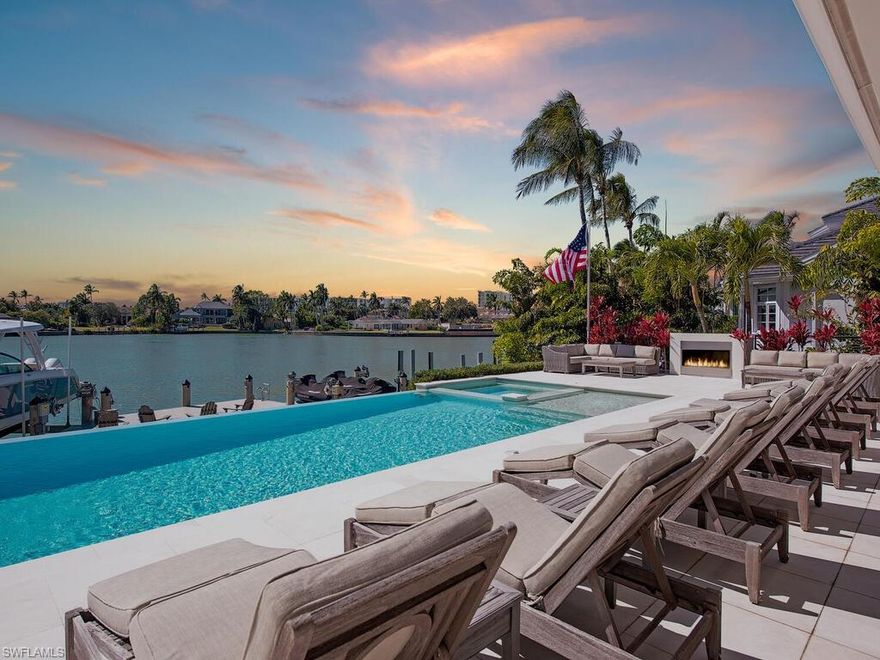 Southern exposure with wide bay views in this beautifully waterfront residence. Offering 6 bedrooms plus study and an expansive gathering room, this home is designed for comfortable living and effortless entertaining. The outdoor living space is exceptional, featuring a large lanai and pool deck overlooking the bay, a private dock with lift and jet ski platforms, and quick boating access to the Gulf. The pool and spa area offers a generous sun deck with excellent sun exposure and a fireplace for evening enjoyment. The home was taken down to the concrete block walls and completely rebuilt, with renovation completed in 12/2014 with Timeless finishes. Thoughtfully updated throughout, it combines quality construction with a functional floor plan ideal for family living and guests.  Located in the Moorings, with convenient golf cart access to the private beach, downtown Naples, and Waterside Shops. Enjoy close proximity to Naples’ renowned beaches, dining, and shopping.