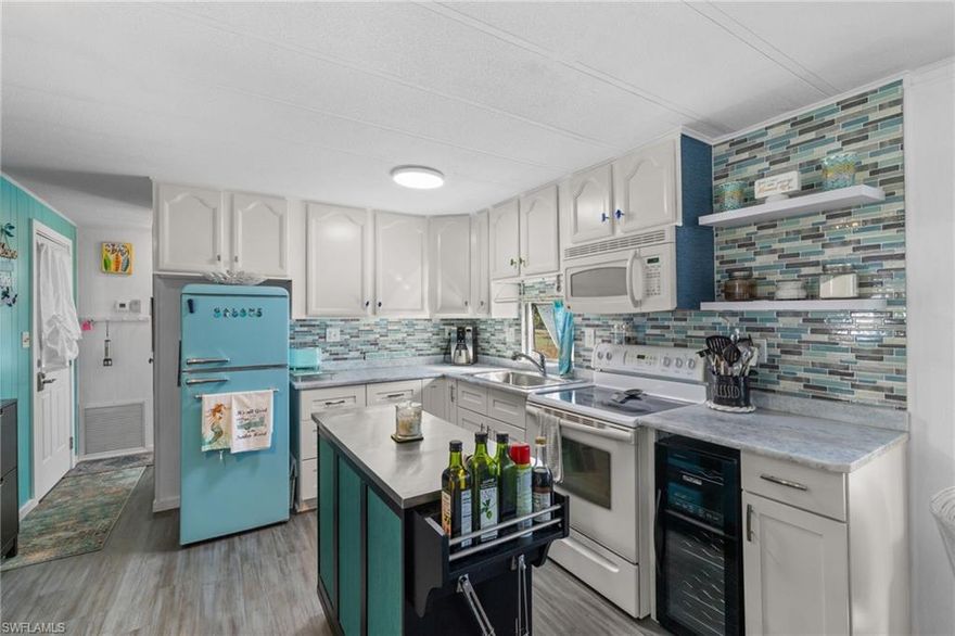 Welcome to 43 Enchanting Way. A charming, coastal-inspired retreat in the heart of Naples’ vibrant 55+ community lifestyle. Updated in 2023 and thoughtfully designed for comfort and ease, this 2-bed, 2-bath home blends modern finishes with that relaxed Florida feel buyers love.

Inside, an open living, kitchen, and dining space showcases Taj Mahal marble countertops, new coastal luxury vinyl plank flooring, and a retro-modern Galanz fridge + freezer combo. New AC ductwork and added insulation beneath the floors provide improved efficiency and peace of mind.

A standout feature is the front porch transformed into an air-conditioned sunroom - perfect as a den, craft room, guest overflow, or your own reading retreat. The home continues to shine outdoors with a private back screened patio ideal for morning coffee or quiet evenings.

For part-time or full-time living, the separate storage and laundry room is a true convenience: your washer and dryer, plus plenty of space for tools, beach chairs, coolers, golf bags, and everything that makes the Naples lifestyle effortless.

Enjoy low-maintenance living with water, trash, and sewer included in the monthly HOA fees, all within a welcoming 55+ community known for its amenities and social atmosphere. You’ll find a relaxing pool, library, community center, and billiards room all maintained by your low HOA fees. Additionally you can pay $250 a year to PARK YOUR BOAT and store it in a gated storage area in the back of the community. You won’t find boat storage for that low rate anywhere else. 

This location is just 5 minutes to the Bayshore art district where you’ll find the national pickleball championship courts, botanical gardens, public boat ramp, dining, and more. Just a short 10 minute drive leads you to the famous 5th avenue and pristine beaches Naples has to offer. 

Offered furnished with exclusions, this home invites you to step right into the coastal-luxury lifestyle.

Experience relaxed Florida living at 43 Enchanting Way.