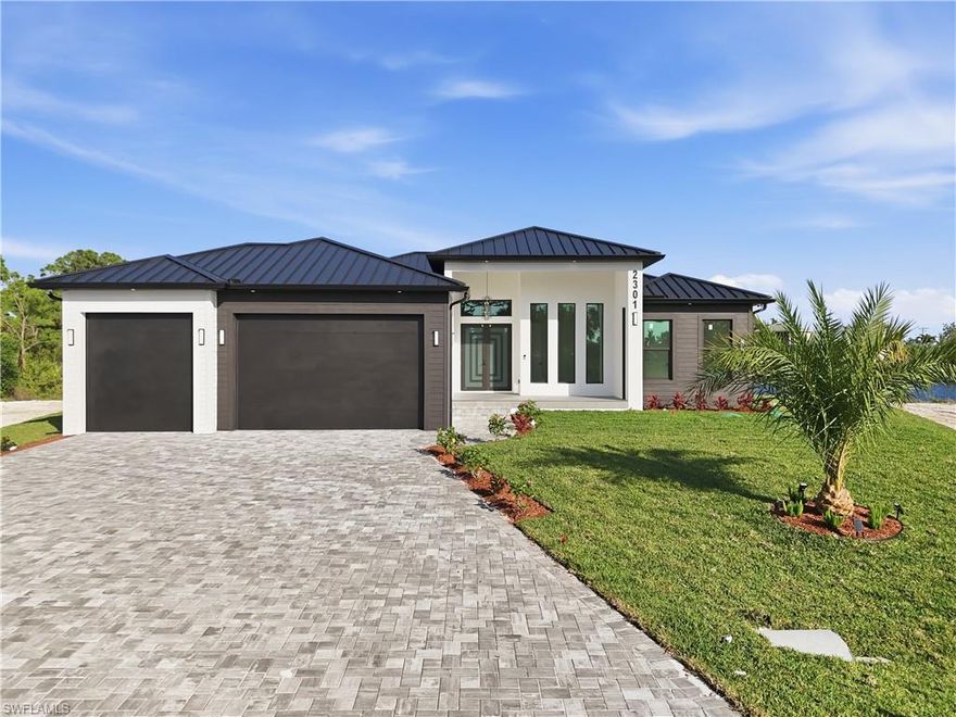 Welcome to this stunning luxury new construction home at 2301 NW 32nd Pl, where modern design meets waterfront living at its finest. This 4-bedroom, 4.5-bath with a insulated triple car garage with 10 foot doors,this stunning residence sits on a prime Gulf-access lot, offering direct boating opportunities and breathtaking canal views. Step inside to discover soaring high ceilings, sleek modern cabinetry, and a state-of-the-art  speaker system and a reverse osmosis water system. Expansive sliding glass doors seamlessly connect the indoor living space to your private outdoor oasis, showcasing a resort-style pool complete with spa, screened enclosure, elegant paver deck, and a fire pit for unforgettable evenings. The show-stopping pool features a swim-up bar with in-water seating, perfect for entertaining. Enjoy the fully equipped outdoor kitchen, ideal for hosting gatherings year-round. Additional highlights include a full security camera system for peace of mind and thoughtfully designed spaces that blend comfort, style, and functionality. This is waterfront luxury living redefined.