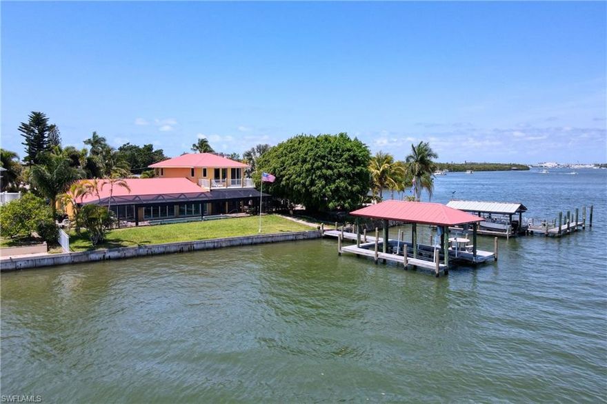 Your best Florida lifestyle awaits on the Back Bay of Fort Myers Beach in this sprawling estate home! Hop on your boat & head to the Gulf from this beautiful waterfront pool property with panoramic views of the open bay. The floor plan of this home is ideal for effortless entertaining with the open kitchen, 3 spacious ensuite bedrooms, 3 spa-style bathrooms all extensively updated with designer features and modern conveniences. Boaters will delight with the nicely maintained boathouse, 10,000 lb boat, quick access to the Gulf, and large composite deck for fishing or watching the famous Florida sunsets. Enjoy the beauty of living on this quiet cul de sac with its tropical, low-maintenance landscaping and freshly painted exterior. Storm protection is provided with the metal roof, convenient impact-resistant windows/sliders, & an oversized 2 car garage with new door plus storage. Located mid-island, the home is nestled in a wonderful boating community with beach access, shopping, restaurants, schools, & Publix supermarket. If you're searching for the ideal place to live & play, look no further than this amazing waterfront home!
