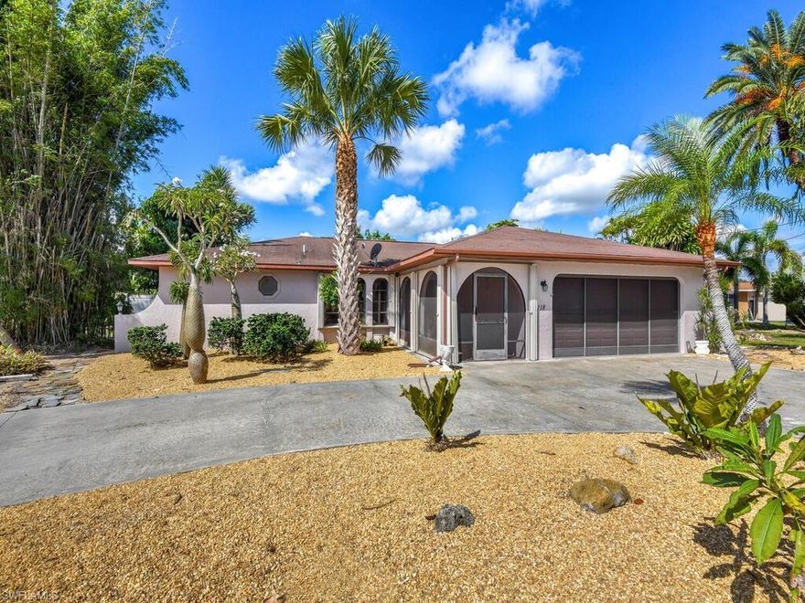 Welcome to the Oasis on 10th!  Situated on an oversized corner lot on a quiet street, this home has been lovingly maintained throughout the years, and was even featured in "The Cape Coral Breeze" for it's lush exotic landscaping across the entire property!  The interior of this 2 BR/ 2 bath home boasts vaulted ceilings, expansive living space, spacious open concept kitchen, 2 en suites with walk in closets & tastefully remodeled baths, freshly painted walls, NEW plush carpet, and Newer HVAC & Water Heater.  Enjoy entertaining friends and family as the indoors seamlessly flow outdoors with large pocket sliders leading to the screened lanai which overlooks your own fully fenced serene oasis that offers privacy and peace of mind.  Sit on the lanai, enjoy your favorite beverage, and be mesmerized at the sounds of nature as the birds enjoy the vast array of trees, shrubs, & plants that include multiple species of palms, exotics, bromeliads, plumeria, and more!  With 8/10 of an acre, there's endless options to make this home your very own, including plenty of room for a pool!  Hurricane shutters around the whole house is another BONUS!!!  STRONGEST & BEST OFFERS DUE BY 10/11 @ 5pm.