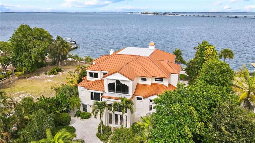Bayfront bliss is found in this stunning, private estate on Sanibel's east end. Located down a quaint and private street this stunning home offers high-quality concrete construction set in an idyllic location. The wonderful floor plan greets you as you enter and notice soaring two-story ceilings for expansive views of the sky as well as the bay. The chef's kitchen features a walk-in pantry, island with cooktop, entertaining bar with seating and custom-cabinetry sideboard running the length of the eat-in kitchen that is perfect for storage or a coffee bar. All five bedrooms each have an en-suite bath and walk-in closet. Located on the main level, the master has dual baths and a walk-in closet. Other features include a summer kitchen with grill, sink, beverage cooler and bar with seating, Resort-style pool with grotto seating area, swim-up table, hot tub, sheer descent waterfall and two-story cage. Elevator to all three stories and private beach overlooking the bay.
