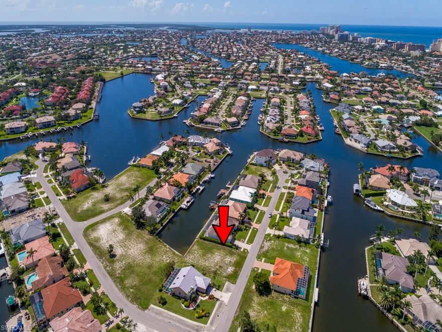 Build your dream home on this oversized waterfront building lot in an area with many new homes.  Close proximity to the beach.  Quick access to the Gulf. Just a short boat ride to shopping and dining at the Esplanade. Seller will pay the outstanding sewer assessment at closing.