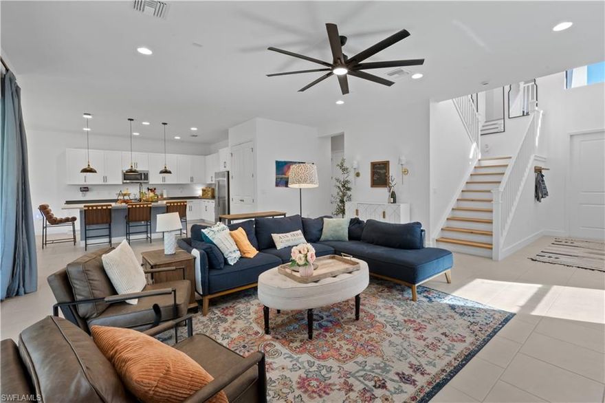 The highly sought-after Olympia floor plan by GL Homes delivers refined luxury designed for the modern, busy family. Recently built and impeccably upgraded, this exceptional residence showcases designer lighting, curated custom wall finishes, elegant millwork, wide-plank white oak flooring, quartz countertops, and a bespoke speakeasy-style wine nook—each detail thoughtfully selected for both beauty and function.

The expansive floor plan offers space to gather, work, and unwind with ease. A rare main-level bedroom with a full bath provides ideal flexibility for guests or multigenerational living. Two sophisticated family rooms—one upstairs and one downstairs—allow everyone their own retreat, while a large private office with French doors creates a quiet, work-from-home haven. In total, the home features 4 generously sized bedrooms, 5 full bathrooms, and nearly 4,000 square feet of beautifully appointed living space!!

Outdoors, the private western-facing backyard is framed by mature flowering trees and offers a deep, grassy lawn—perfect for play, pets, or sunset entertaining. A 3-car garage with mudroom entry keeps daily life organized, while soaring ceilings and oversized closets add to the home’s airy, luxurious feel.

Additional highlights include natural gas cooking, hurricane-rated doors and windows, low HOA fees, fencing permitted, and no flood insurance requirement—practical luxuries that truly matter.

Set within an amenity-rich, resort-style community, residents enjoy a pool and spa, yoga room, indoor sports court, fitness center, fire pits, playground, tennis, bocce, and pickleball. Ideally located just minutes from I-75, RSW Airport, FGCU, Hertz Arena, Publix, Miromar Outlets, and Gulf Coast beaches—this home offers seamless living for families who value time, comfort, and elevated design.