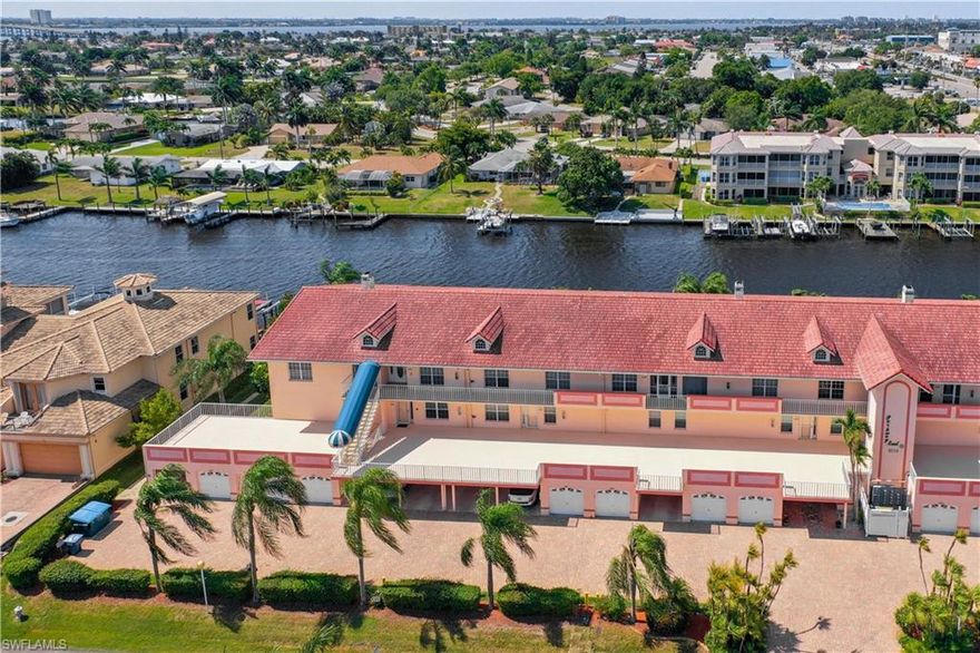 WOW. Waterfront on direct access Canal to the River and Gulf. Overlooking your private remote controlled 12,000lb Boat Lift. New Common Composite Decking, Tiki Hut with Common Gas Grill & River Front Inground Pool Centrally located, close to everything.This Corner unit faces South and has Open Floor plan from Kitchen through to the enclosed Lani. Views are stunning. Lots of Counter Space and eat in Breakfast Area. Oversized Great Room opens with 4 sliders to Glass&Screened Lanai. Built In Bar and nook off Living Room. Double Door Den is directly adjacent to Kitchen and Living Areas. Master Bedroom has coffered ceiling  & private screened Lanai, overlooking Canal. Master Bath is L-Shaped 17x 12 approximately. Double bowl raised 8 ft.vanity, soaking Tub, walk in shower, walk in closet,separate water closet and linen closet. Guest Bedroom has  double closets . Newer Entrance Steel Door and Hurricane Glass. Guest Bath has walk in Tile Shower and large single bowl vanity. Small Friendly Complex. Each unit has a one car garage and unit owners are required to park in their garage except townhouses that have extra parking space. Some guest parking. AC about 2017 Unit re-plumbed through out