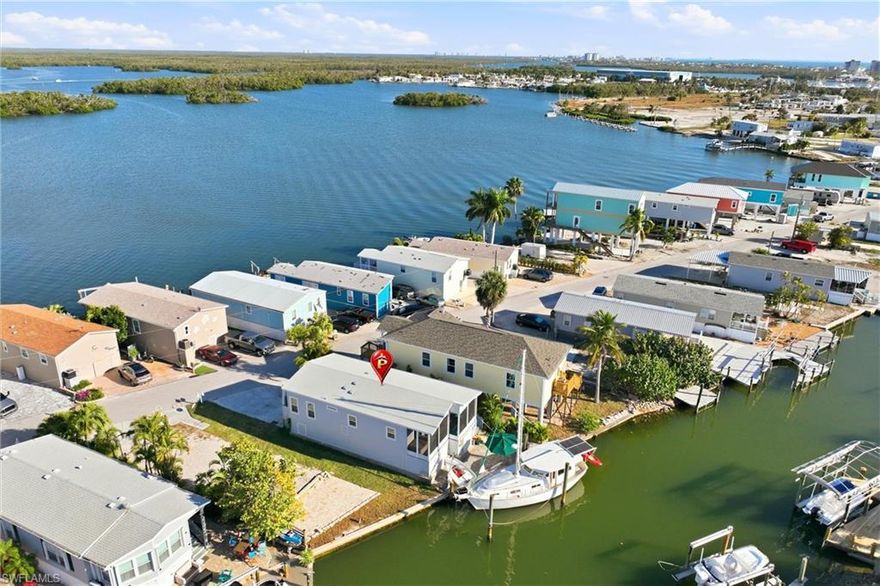 Welcome to a beautifully updated coastal retreat offering direct Gulf access and an unbeatable Fort Myers Beach location.  Just a short walk to popular waterfront restaurants and the Key West Express and a quick bike ride over the bridge to Fort Myers Beach, this home delivers the ultimate Southwest Florida lifestyle.  This 2 bedroom, 2 bathroom furnished residence features a bright, modern coastal design with 9 foot ceilings, a cozy fireplace, and an open concept layout ideal for entertaining or relaxing.  The updated kitchen includes quartz countertops, new appliances, a beverage cooler, and a washer and dryer conveniently located in the kitchen.  The primary suite offers custom built-ins, a double closet, and a private bathroom.  Step outside to enjoy the back patio with hot tub and composite decking, and storage underneath- perfect for bikes, beach gear, and water toys.  Whether you're seeking a full time residence, vacation getaway, or income-producing property, this home offers exceptional flexibility with no rental restrictions and no age restrictions- a rare find in an area surrounded by 55+ communities.  Enjoy true island living with freedom, convenience, and an unbeatable Fort Myers Beach location.