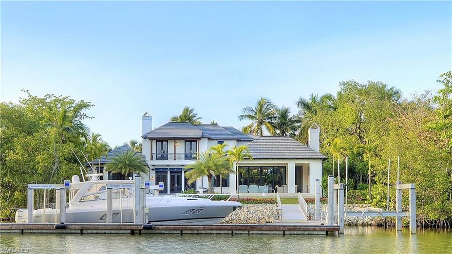 This multiple award-winning custom residence, designed by Kukk Architecture and built by A. Vernon Allen Builders, with interiors by W Design, exudes character, charm and outstanding quality. Attention to detail and craftsmanship is evident from the moment one steps into the home. Completed in 2016, it is located on the most prominent S.W. facing waterfront lot in Little Harbour, a guard gated community within Olde Naples’ Port Royal neighborhood. Brilliant southern exposure with an expansive outdoor living and pool area further add to the appeal of this meticulously maintained and designed home. A boater’s dream, this unique property features 142’ of waterfrontage on Jamaica Channel, an Ipe clad 73’ Bellingham floating concrete boat dock and a 40,000 lb. boat lift, which can accommodate a 50’ vessel, with direct no-bridges access to Naples Bay and the Gulf of Mexico. Little Harbour owners qualify for associate membership in the coveted and prestigious Port Royal Club, located beachfront on the Gulf of Mexico.