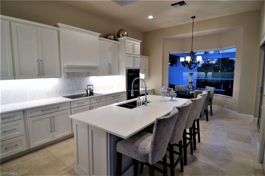 SIMPLY SPECTACULAR ! !  Beautifully upgraded 2 story Arthur Rutenburg Model with Brand New Roof.  Generously sized accommodations with over 3400 sq. ft. under air, 3 BR plus oversized loft, family room and private his/her office with wood desk and built-ins. Custom features and appointments throughout. Separate living and dining room areas featuring volume ceilings, recessed lighting and 6” baseboards in all rooms.  A fabulous island style kitchen with 42” all new white wood cabinets, new GE appliances, CARRARA marble countertops, a walk in pantry, built-in desk and more.  New travertine marble in main living area, complimented by carpeting and wood.  Large master suite appointed with walk-in tiled shower, CARRARA marble, Jacuzzi tub, bidet and two custom California closets. 
Upstairs you will find plenty of privacy for your guests with 2 bedrooms / full bath and a lovely lounge area.   Outside you will enjoy your SE exposure while lounging in your over sized heated swimming pool with paver lanai deck and spacious dining and sitting area. Social club membership included for all homeowners.  Affordable golf dues are optional.