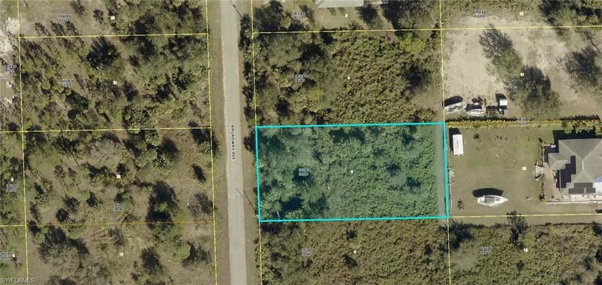 Residential half acre building lot on a nicely paved street.