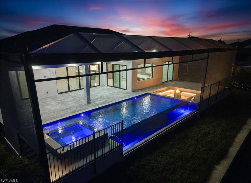 Welcome to 109 NE 5th Ter, Cape Coral, FL 33909, a spectacular new construction waterfront home situated on an oversized triple lot in a desirable Cape Coral neighborhood. Designed with modern elegance and Florida outdoor living in mind, this residence offers a rare combination of space, privacy, and resort-style amenities.

The exterior is truly the centerpiece of the home. A negative-edge infinity pool with a heated spa creates a striking visual as it flows seamlessly toward the wide canal. Positioned next to the pool is a cozy yet luxurious outdoor fireplace and built-in gas fire pit, forming the perfect setting for relaxing evenings or entertaining guests. The panoramic screened lanai with super screen enhances the waterfront views while providing comfort, privacy, and year-round usability.

This outdoor retreat is further complemented by a fully equipped outdoor kitchen, outdoor shower, elegant water features, and an automated irrigation system. Impact-resistant Low-E windows and doors help keep the home energy efficient and cooler, while also providing superior storm protection. The expansive triple lot offers ample room for a boat, RV, or future additions, making this property as functional as it is impressive.

Inside, the home features four bedrooms, three bathrooms, and approximately 2,723 square feet of living space, thoughtfully designed with a split-bedroom floor plan for privacy and comfort. Italian ceramic tile flooring, tray ceilings, custom built-ins, and surround-sound prewiring elevate the interior design. The kitchen showcases high-end appliances, a large center island, pot filler, and premium finishes ideal for both daily living and entertaining.
Additional highlights include a three-car garage with storage space, Pentair pool equipment with a dual pump system for optimal water circulation, a beach-style pool entry, and a sleek glass-style pool finish. Assessments are paid, and the property is connected to central water and sewer.

Located in Cape Coral, this exceptional home offers convenient access to shopping, dining, schools, and major roadways, while still delivering the privacy and luxury expected from a high-end waterfront residence. This is a rare opportunity to own a brand-new luxury home on a triple lot with an infinity-edge pool, spa, and outdoor fireplace in Cape Coral, Florida.