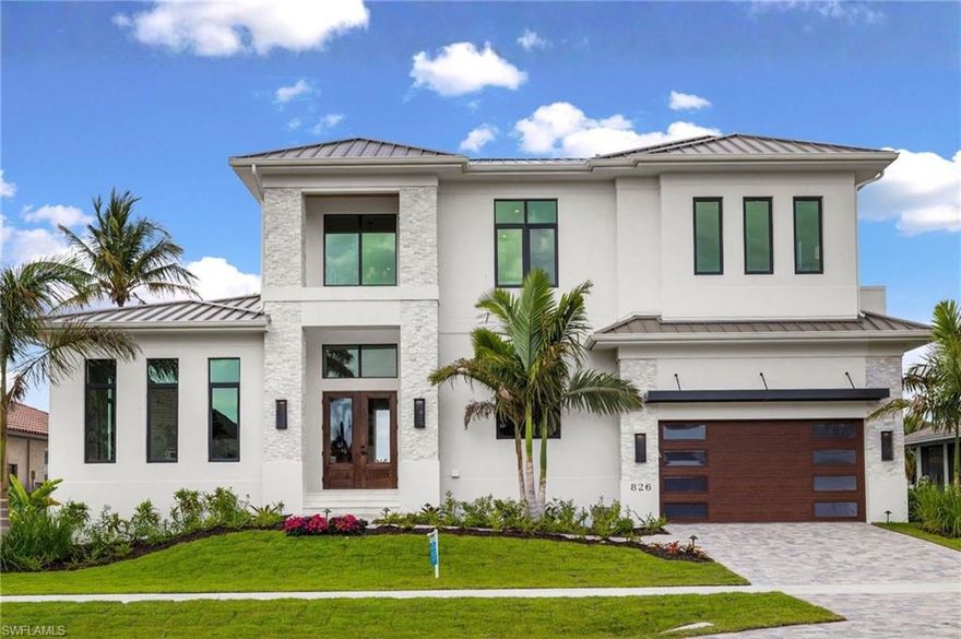 AVAILABLE brand new construction. Deep Water/DIRECT ACCESS/No Bridges only minutes to open water! Updated weekly drone footage. 80 feet of brand new seawall. Award winning custom home built by The Lykos Group, Inc. and designed by South Florida Architecture. Introducing an exceptional opportunity to own a brand-new luxury residence on Marco Island. The two-story Magnolia Model will be approximately 4,235 square feet of living area with a luxurious outdoor living space includes an outdoor kitchen with a spacious deck with a custom pool and spa. The first floor of the open-concept design includes an impressive great room and dining area opening to the outdoor living area, a luxurious master suite with two walk-in closets and a sitting area and a private study. An elevator to the second floor opens to a loft area with wet bar along with three guest suites, one of which opens to your outdoor oasis. Truly a must see! Begin living your dreams of waterfront living with open access to the Gulf of America.