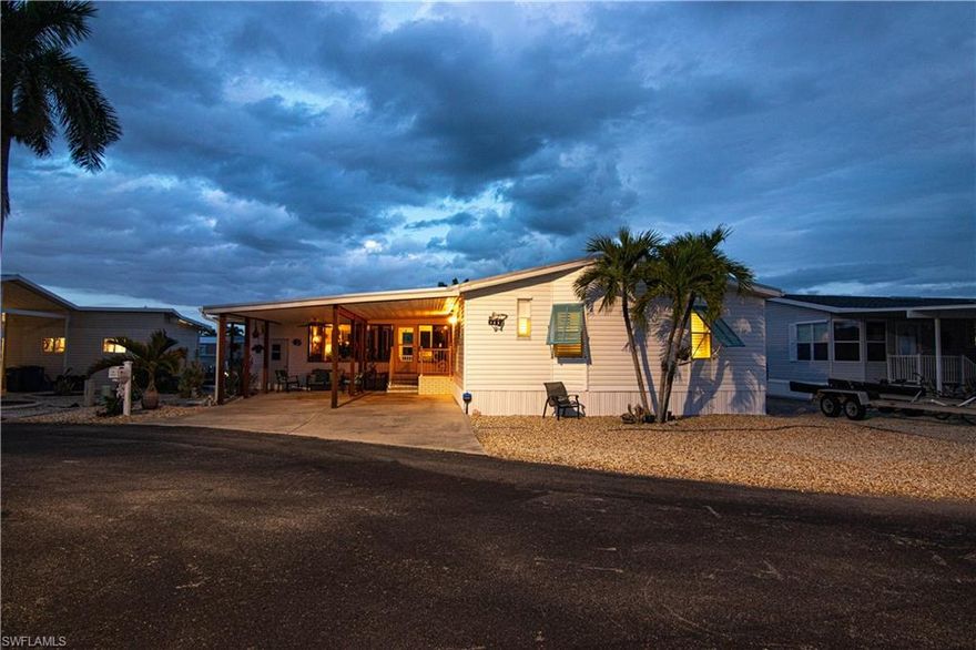 Positioned on a desirable street in Cherry Estates, this updated 2-bedroom, 2-bath manufactured home sits on an oversized, manicured cul-de-sac lot—offering space, privacy, and serious boating capability.

This is a true boater’s setup. Deep water canal access with quick, no-bridge routes to open water provides direct access to Pine Island Sound, the Gulf, Cayo Costa, and Upper Captiva. The dock is built for real use, featuring a new 10,000 lb covered boat lift (2024) upgraded with GEM controls and remote, a captain’s walk, and an additional 1,850 lb davit for a skiff or flats boat.

Inside, the home is clean, updated, and easy to live in. New Coretec flooring runs throughout, complemented by an upgraded kitchen with a large island, newer cabinetry, updated lighting, and plantation shutters throughout—keeping the space bright, functional, and comfortable.

The lanai extends the living space outdoors, creating a true indoor-outdoor setup, and is equipped with a portable air conditioner for added comfort year-round.

Major systems and improvements are already handled, including a metal roof, newer HVAC with WiFi controls, updated carport and lanai roofs, storm protection, and a security system with three WiFi-enabled cameras already in place. The home also remained dry during Hurricane Ian.

Out back, the composite dock and seating area create a functional waterfront space, while the reinforced seawall and drainage improvements support long-term stability. A large storage shed adds additional utility for tools, gear, or fishing equipment.

Parking is another advantage, with a large carport and additional space that’s hard to find in this area.

Located in Cherry Estates, a boating and fishing-focused community with a voluntary HOA, this section offers a well-laid-out setting with strong overall positioning compared to older areas.

Offered mostly furnished—including a sofa and loveseat that both convert into sleeper sofas—this is a straightforward waterfront property that delivers where it matters: access, updates, and usability.